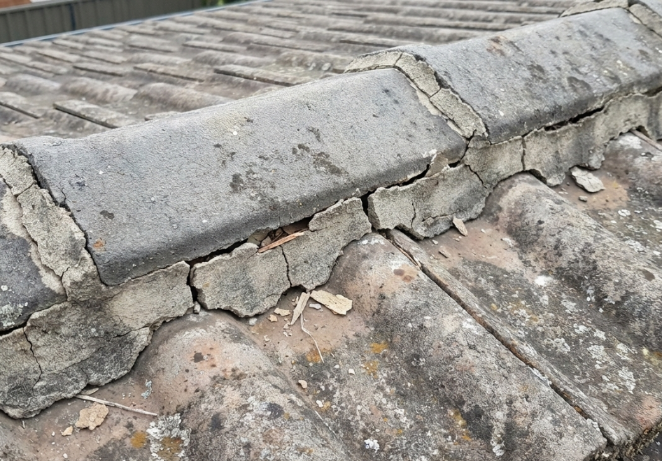 Deteriorated ridge cap and pointing on a tile roof